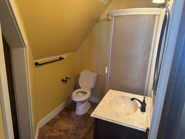 bathroom featuring walk in shower, baseboards, toilet, vaulted ceiling, and vanity