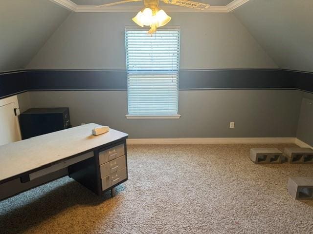 carpeted office with vaulted ceiling, a ceiling fan, and baseboards