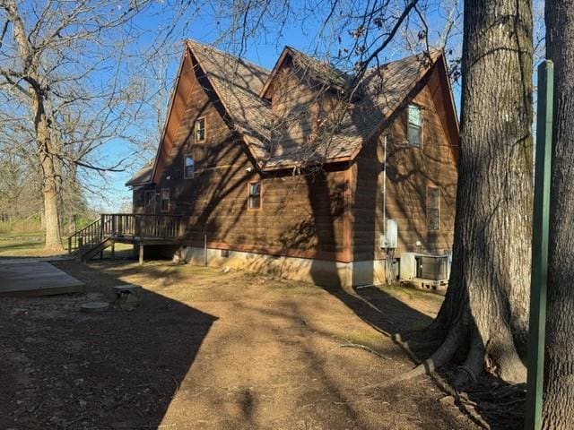 view of side of home featuring a wooden deck