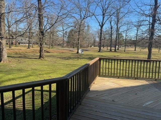 wooden deck featuring a lawn