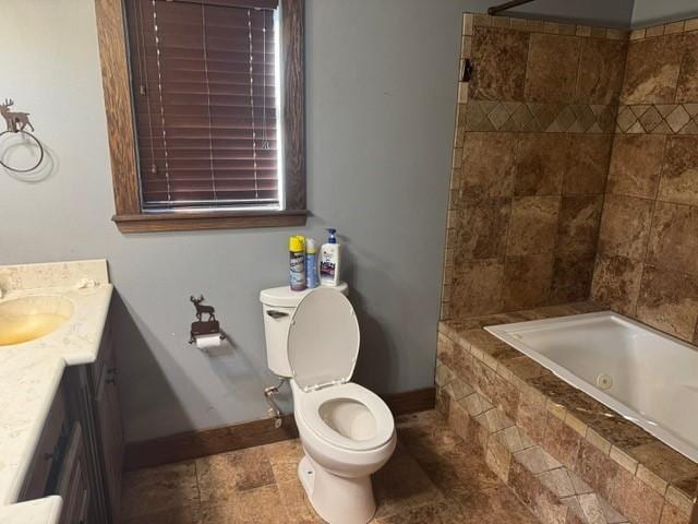 bathroom featuring toilet, vanity, and baseboards