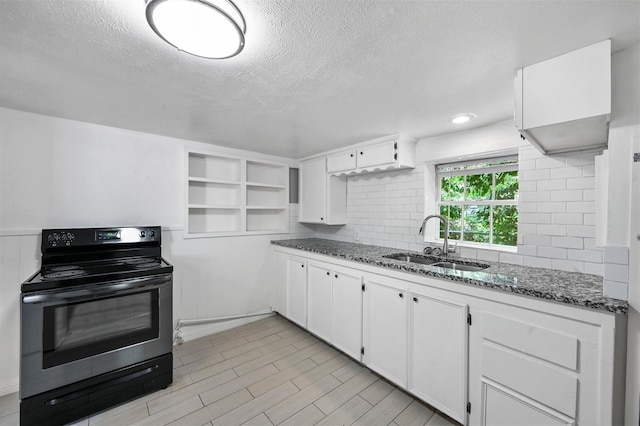 kitchen with a sink, open shelves, backsplash, black range with electric cooktop, and white cabinetry