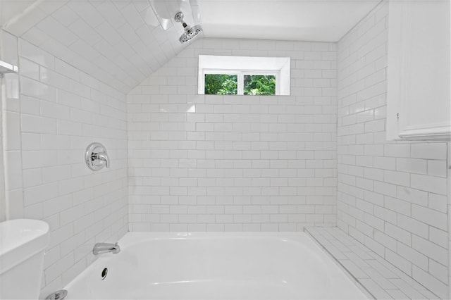 full bath with shower / bathing tub combination, toilet, and lofted ceiling