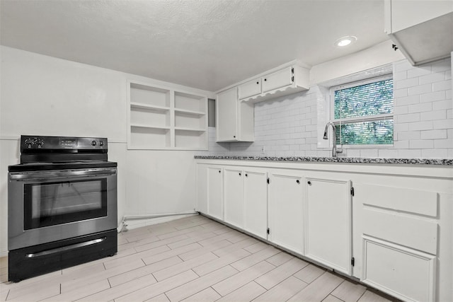 kitchen featuring wood tiled floor, open shelves, decorative backsplash, white cabinets, and electric stove