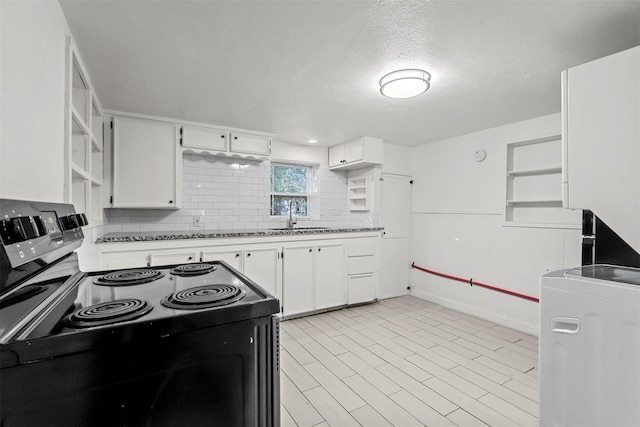 kitchen featuring washer / dryer, electric range, open shelves, a sink, and white cabinetry