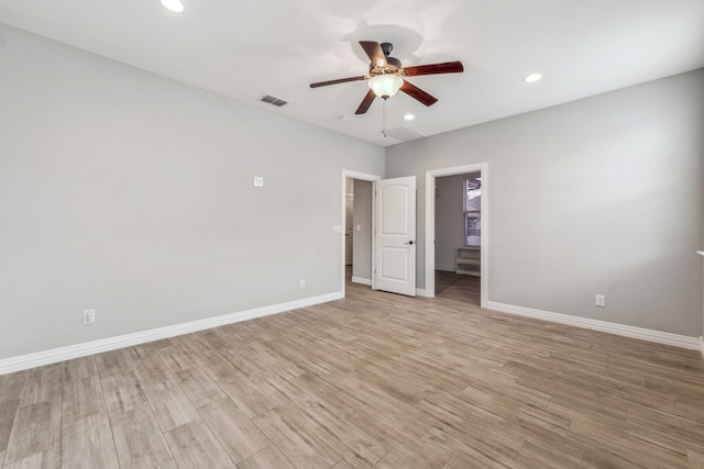 spare room featuring visible vents, light wood-style flooring, recessed lighting, baseboards, and ceiling fan