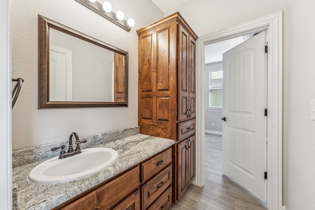 bathroom with vanity and wood tiled floor