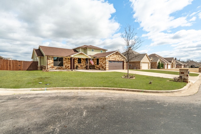 view of front of property with a front yard, fence, an attached garage, concrete driveway, and board and batten siding