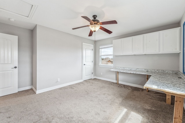 interior space with light carpet, ceiling fan, and baseboards