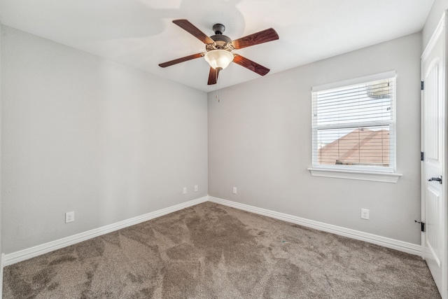 empty room with baseboards, a ceiling fan, and carpet flooring