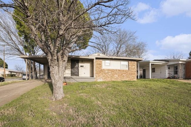 ranch-style house with a carport, driveway, and a front lawn