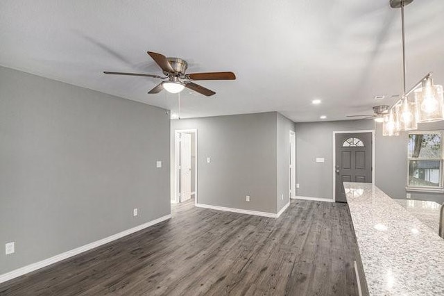 unfurnished living room with dark wood finished floors, recessed lighting, a ceiling fan, and baseboards