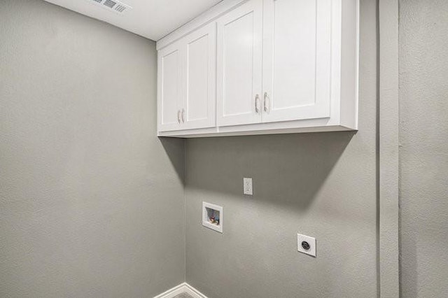 laundry area with electric dryer hookup, visible vents, washer hookup, cabinet space, and baseboards