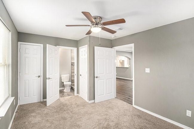 unfurnished bedroom with carpet, visible vents, and baseboards