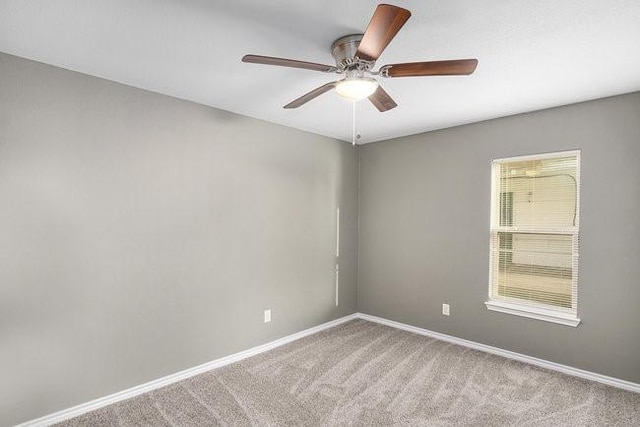 spare room featuring ceiling fan, baseboards, and carpet floors