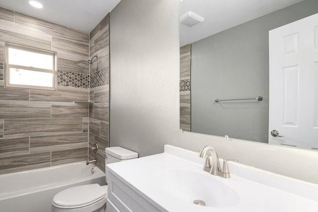 bathroom featuring vanity, toilet, and shower / tub combination