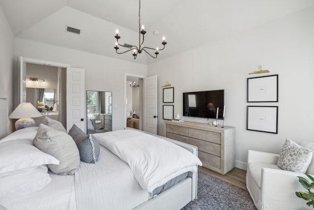 bedroom with lofted ceiling, a notable chandelier, visible vents, and light wood finished floors