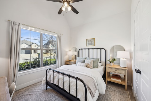 bedroom with vaulted ceiling, a ceiling fan, and baseboards