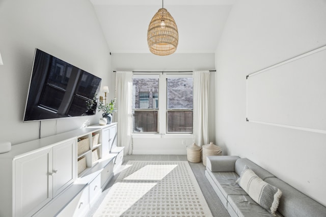 carpeted living room featuring vaulted ceiling