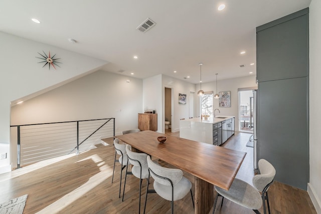 dining area featuring recessed lighting, visible vents, and light wood-style flooring