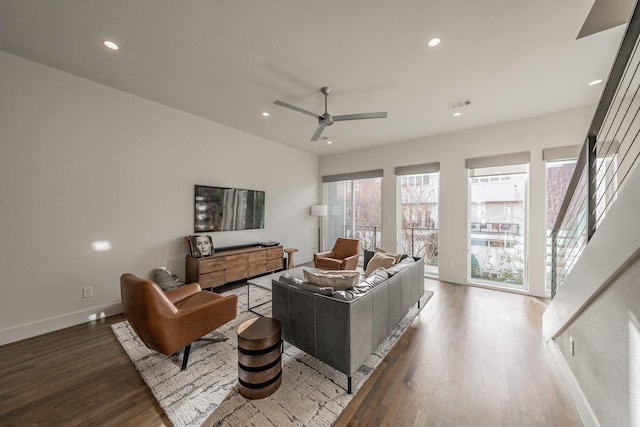 living room with recessed lighting, visible vents, wood finished floors, and stairs