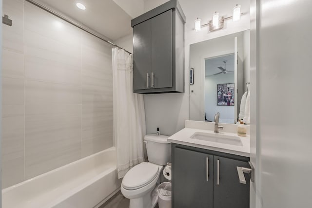 full bathroom featuring toilet, vanity, shower / bath combo with shower curtain, and ceiling fan