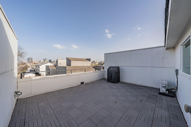 view of patio with a balcony and a grill