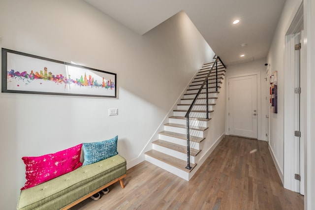 stairs featuring recessed lighting, wood finished floors, and baseboards