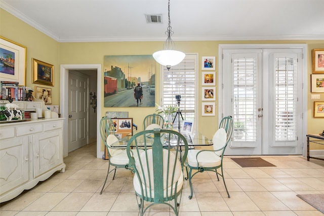 dining room featuring light tile patterned floors, visible vents, french doors, and crown molding