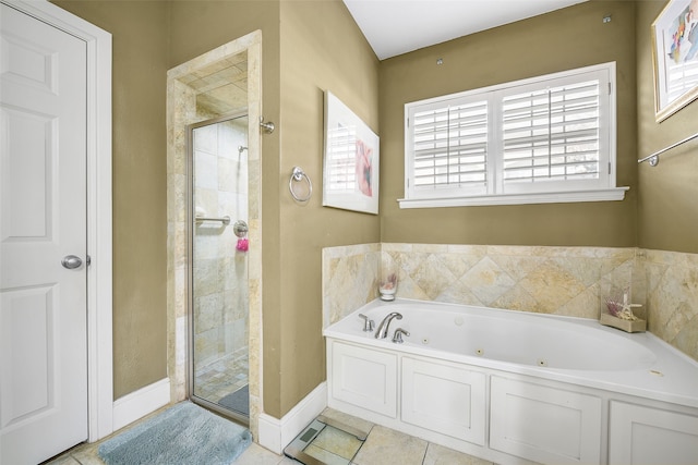 full bath featuring baseboards, a tub with jets, a stall shower, and tile patterned flooring