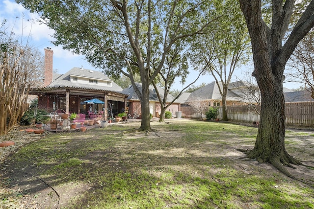 view of yard featuring a fenced backyard, a pergola, and a patio