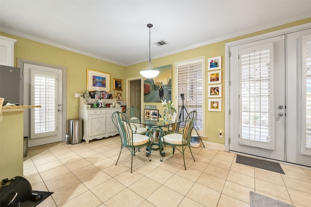 dining area with light tile patterned floors, visible vents, french doors, and ornamental molding