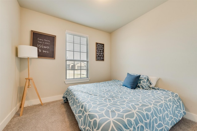 carpeted bedroom with baseboards and vaulted ceiling