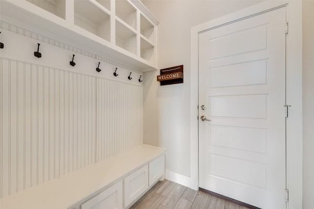 mudroom with baseboards and light wood-type flooring