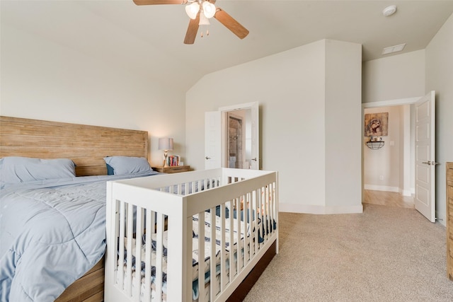 carpeted bedroom with vaulted ceiling, a ceiling fan, and baseboards