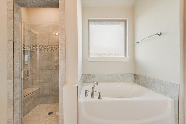 bathroom with a bath and a stall shower