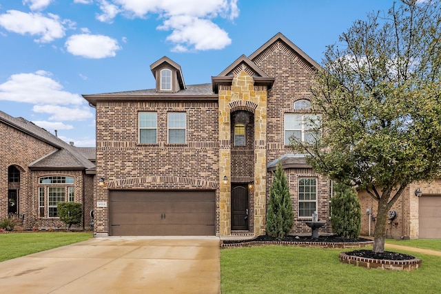 french country home with brick siding, stone siding, concrete driveway, and a front yard