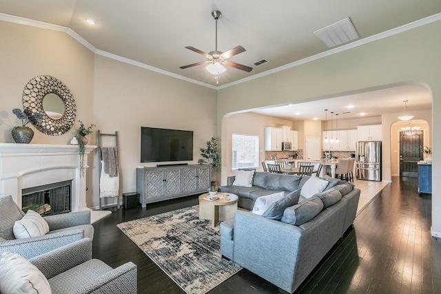 5113 Vieques Ln, Fort Worth, TX 76244 - living area with ceiling fan, dark wood finished floors, recessed lighting, arched walkways, and crown molding