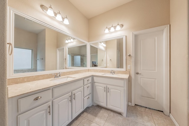 bathroom featuring tile patterned floors, double vanity, and a sink