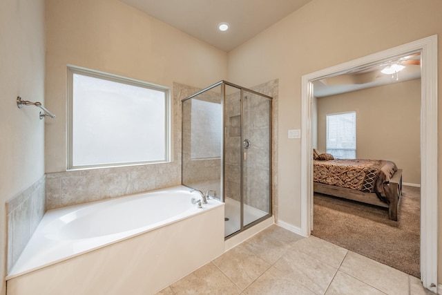 ensuite bathroom with ensuite bath, tile patterned floors, a bath, and a stall shower