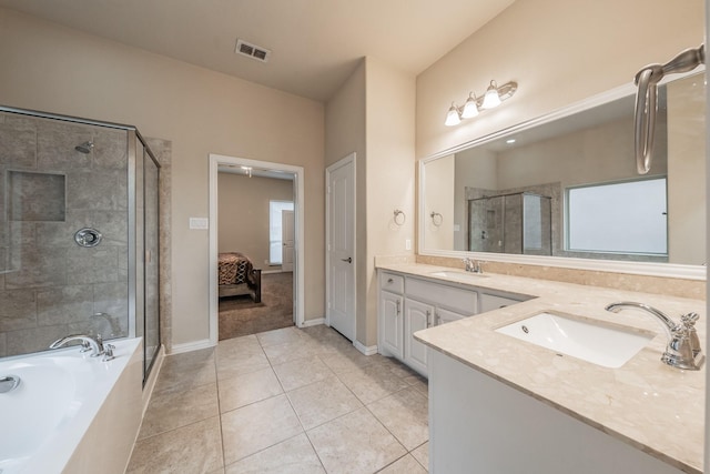 bathroom with double vanity, visible vents, a stall shower, and a sink