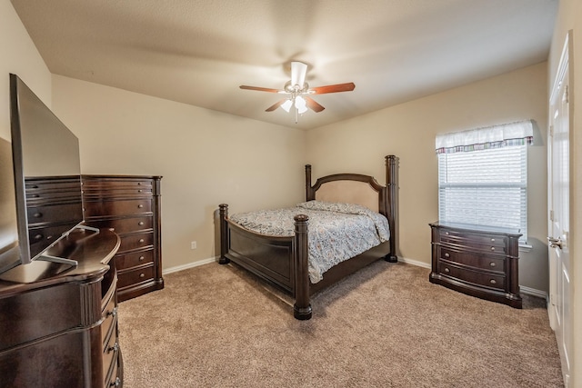 carpeted bedroom featuring ceiling fan and baseboards