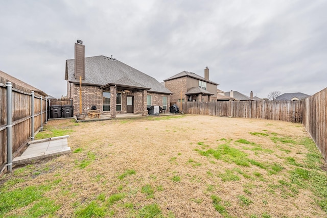 view of yard with a patio area and a fenced backyard