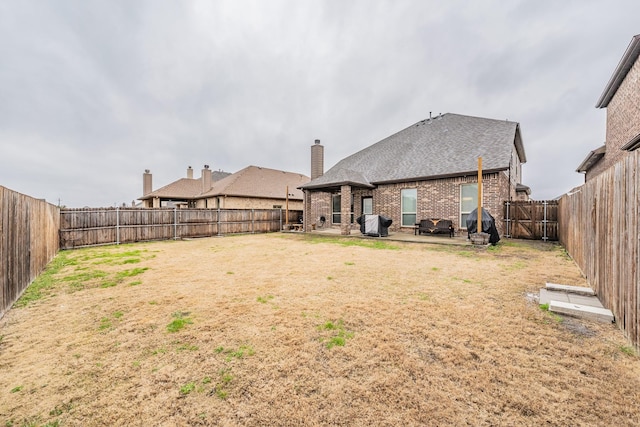 view of yard featuring a patio and a fenced backyard