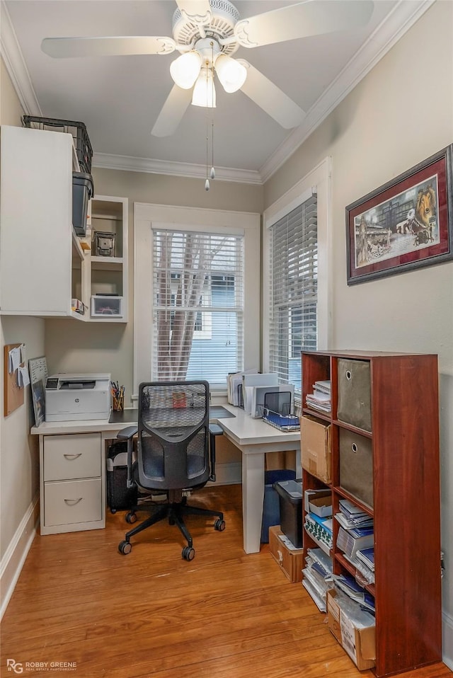 office area with ceiling fan, light wood-style flooring, baseboards, and ornamental molding