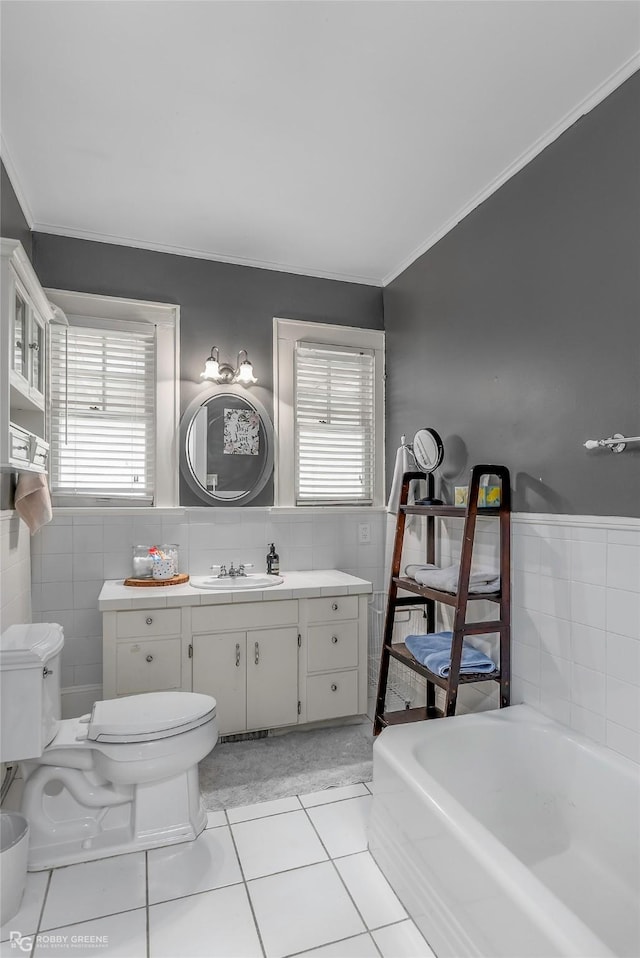 bathroom featuring toilet, tile walls, crown molding, and tile patterned flooring