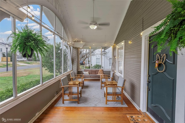 sunroom featuring ceiling fan