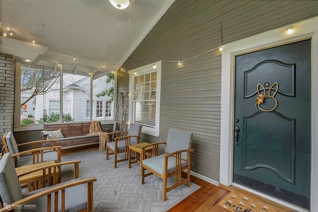 sunroom featuring lofted ceiling