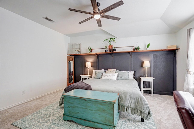 carpeted bedroom featuring visible vents, baseboards, ceiling fan, and vaulted ceiling