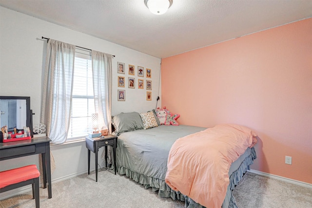 bedroom featuring carpet flooring, baseboards, and a textured ceiling